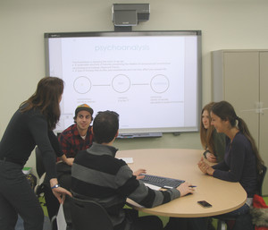 athy and a student team working on a problem in the active learning classroom